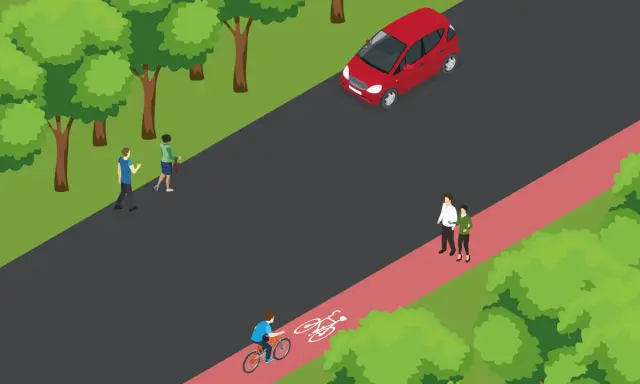 Na ścieżce rowerowej jedzie rowerzysta, a obok idzie pieszy. Czerwony samochód stoi na drodze.