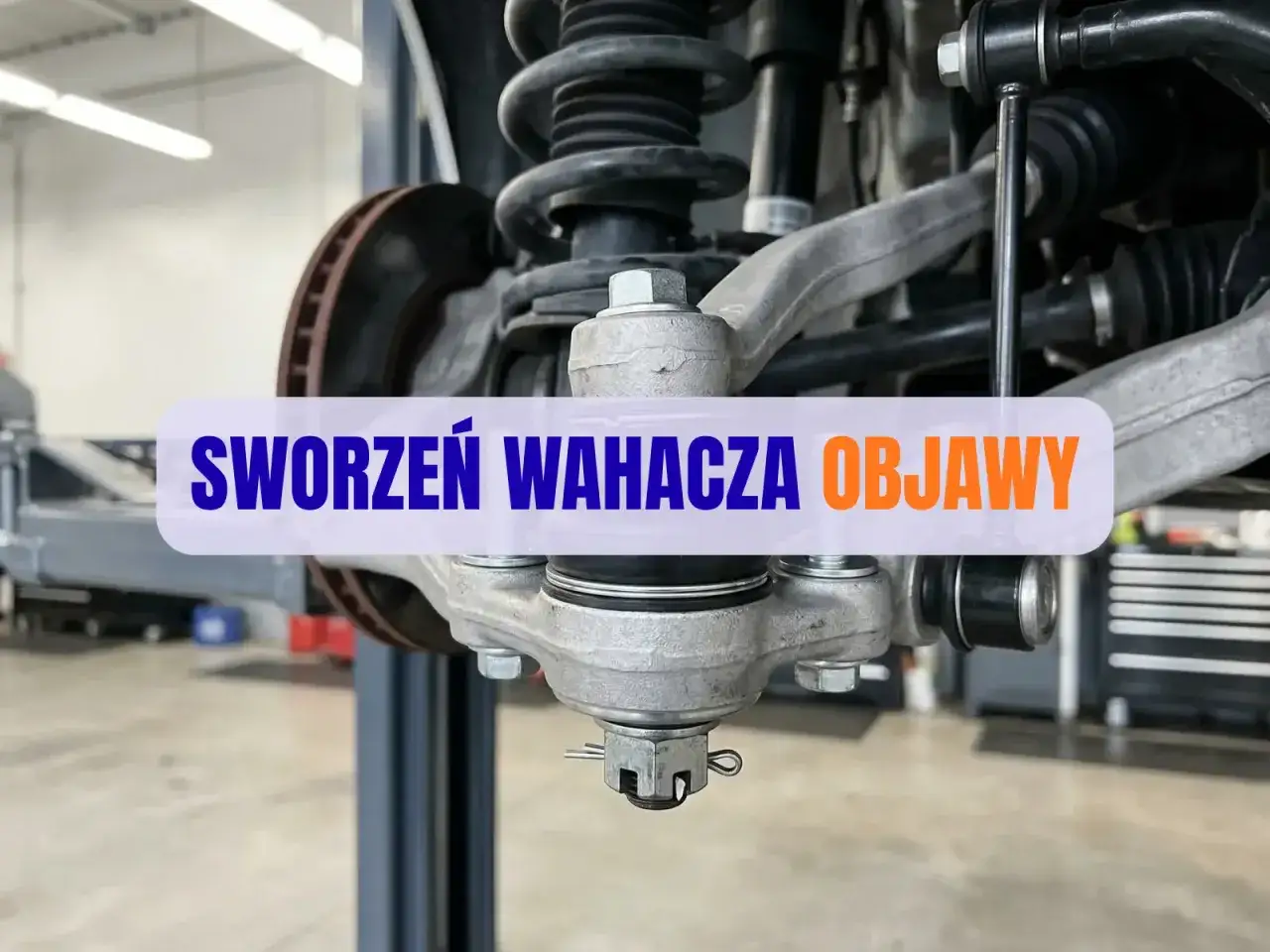 Widoczny sworzeń wahacza w aucie, kluczowy element zawieszenia.