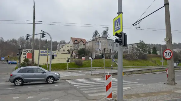 Zielona strzałka gdzie się zatrzymać, sygnalizacja świetlna dla pieszych i samochodów, znak ograniczenia prędkości 30.